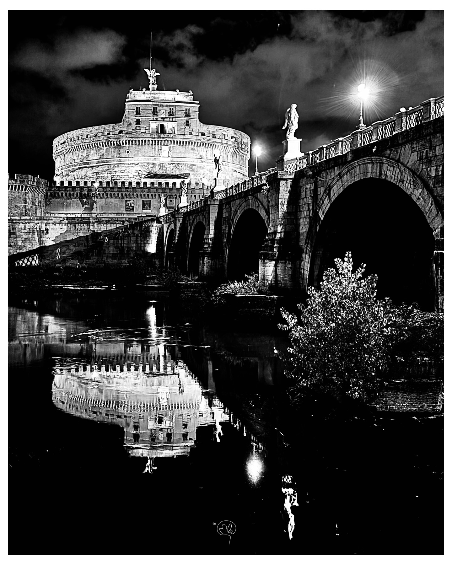 Castel Sant'Angelo and its illuminated bridge at night in Rome